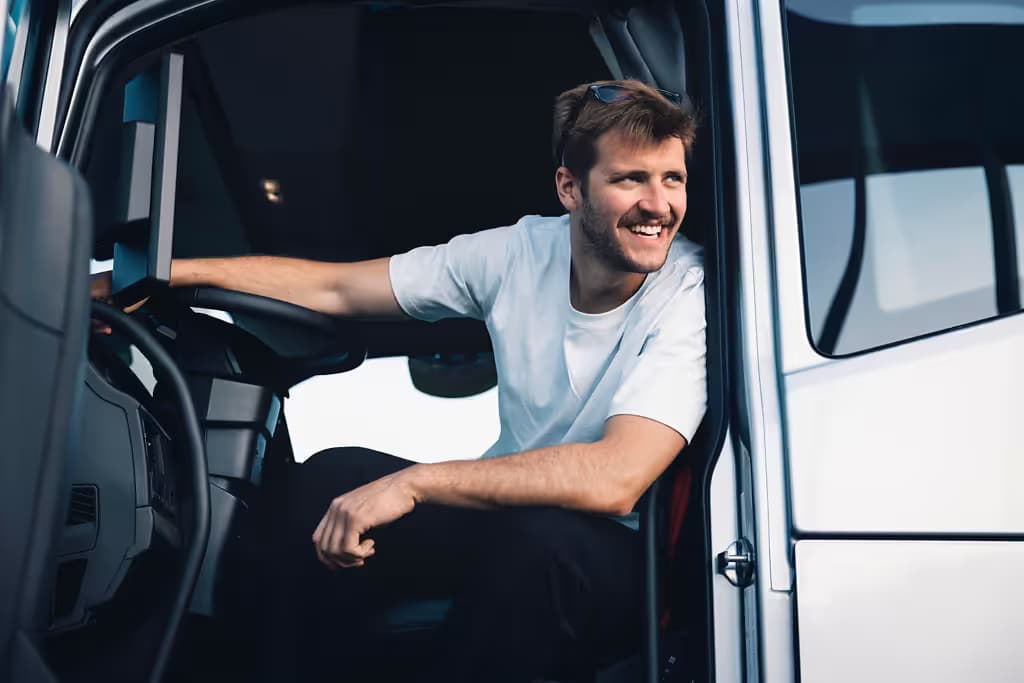 Smiling truck driver in the driver seat